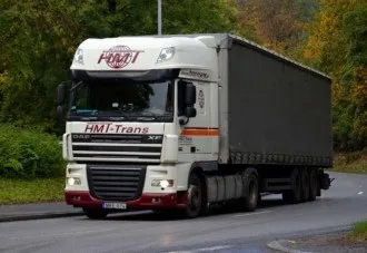 HMT-DAF mit dunkler Plane auf einer Landstraße